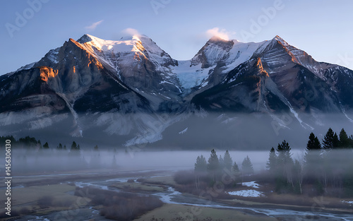 Misty mountains, snow-capped peaks, tranquil valley.