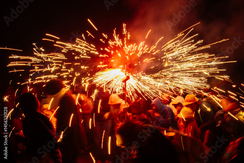 People running with fireworks during correfocs in catalonia
