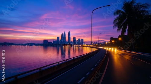 Spectacular sunset over Kuala Lumpur skyline with vibrant reflections on water