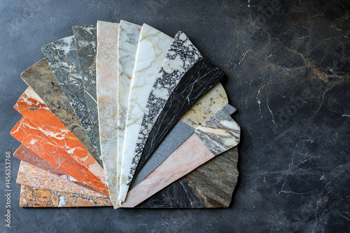 A fan shaped display of various marble slabs showcasing different colors and patterns photo
