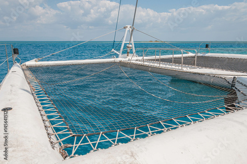 Catamaran netting is taut, providing a clear view of the mesmerizing blue water below