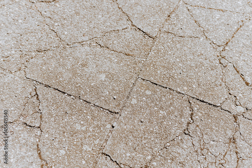 Cracked Concrete Floor Surface Showing Wear and Structural Damage photo