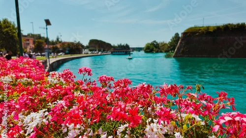 Picturesque canals and fortified walls of Peschiera del Garda in Veneto, Italy nestled on Lake Garda shore