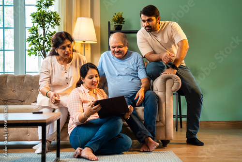 Flipping through old album, Indian family laughs together while reliving cherished moments