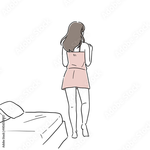 Woman standing in a pink nightgown next to a bed
