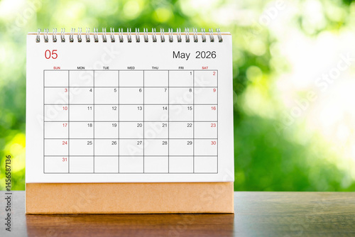 May 2026 Calendar desk for organizer to plan and reminder on wooden table.