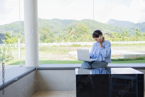 Wallpaper Mural Digital nomad works happily in coffee shop using laptop and phone with scenic mountain view in background for business in relaxed setting Torontodigital.ca