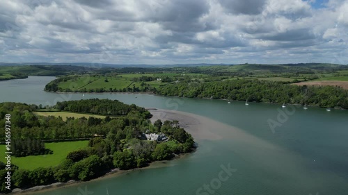 Greenway, River Dart, South Devon, England: DRONE VIEWS: Flying northwards over moored boats and properties on the River Dart. South Devon is a popular UK holiday destination.