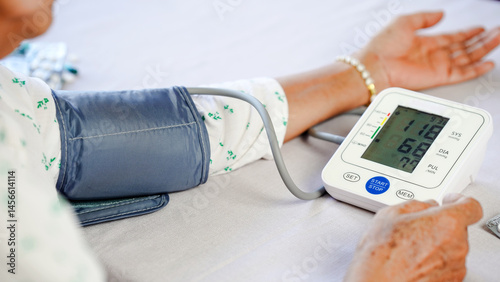 Blood pressure monitor, elderly woman, healthcare, medical device, arm cuff, digital display, home check
