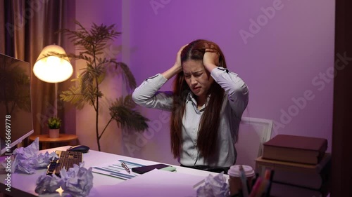 a businesswoman works late into the night because she has to deal with important contract documents that ned to be presented tomorrow, one of the employees worked overtime
