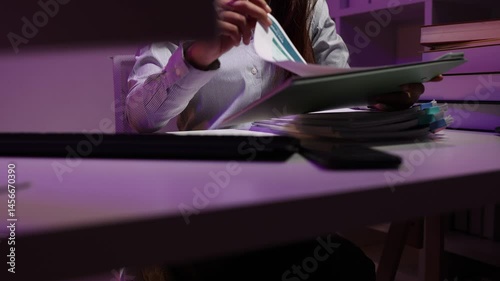 a businesswoman works late into the night because she has to deal with important contract documents that ned to be presented tomorrow, one of the employees worked overtime