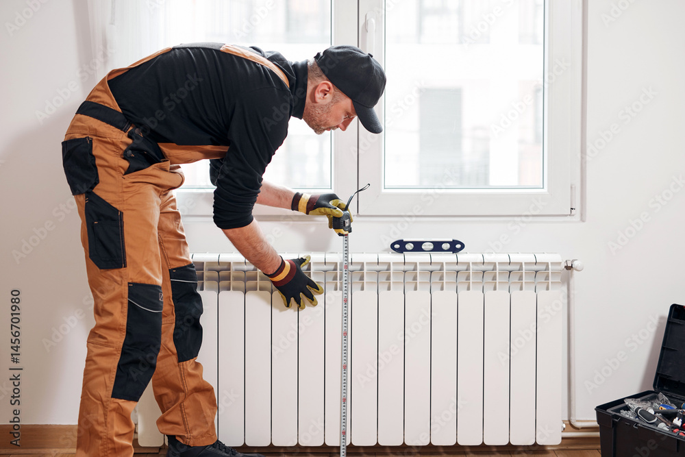 Central heating mechanic and handyman fixing home radiator, gas crisis and seasonal issues.