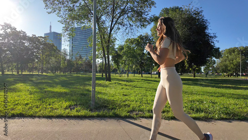 Obraz na płótnie Young woman running and jogging in urban park. w salonie