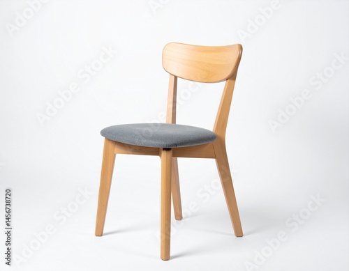 Obraz na płótnie Light wood chair with gray seat cushion stands isolated against a white backdrop in simple elegance w salonie