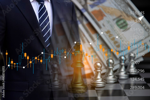 The concept of a businessman trading stocks, chess represents winning.
