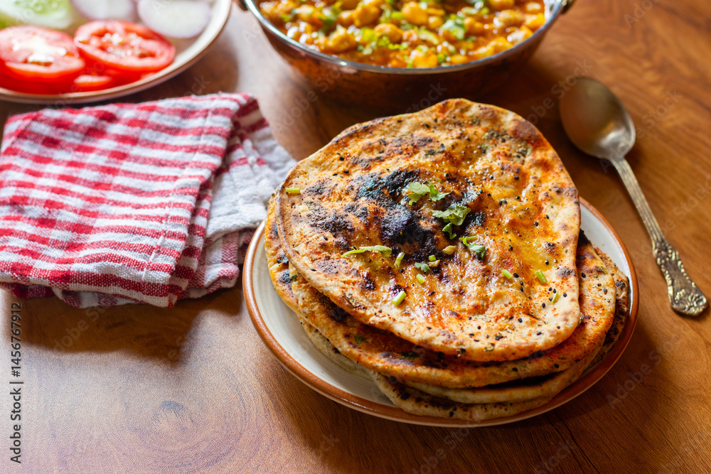 Amritsari kulcha is a crispy, flaky stuffed flatbread from Punjab, filled with spiced mashed potatoes or paneer, baked in a tandoor, and served hot with kabuli chana masala and salad
Amritsari kulcha is a crispy, flaky stuffed flatbread from Punjab, filled with spiced mashed potatoes or paneer, baked in a tandoor, and served hot with kabuli chana masala and salad