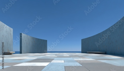 Obraz na płótnie Minimalist open plaza with curved blue walls, geometric tiles, benches, and a clear view of the sea under a cloudless sky. w salonie