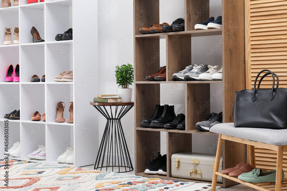 Fototapeta premium Shoe storage. Shelving units with different footwear and other furniture indoors