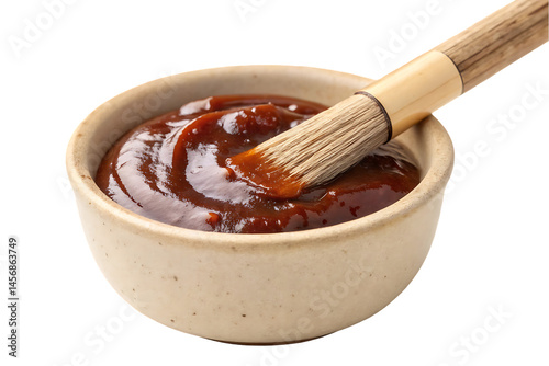 Delicious homemade barbecue sauce in a ceramic bowl, ready for grilling and cooking, with a basting brush.