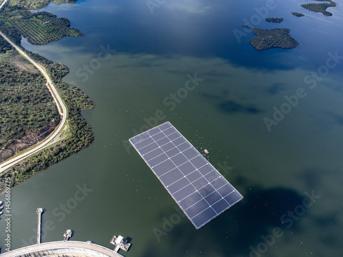 Floating solar panels on the Alqueva Dam waters in Alentejo, Portugal, showcasing renewable energy innovation in a rural landscape.