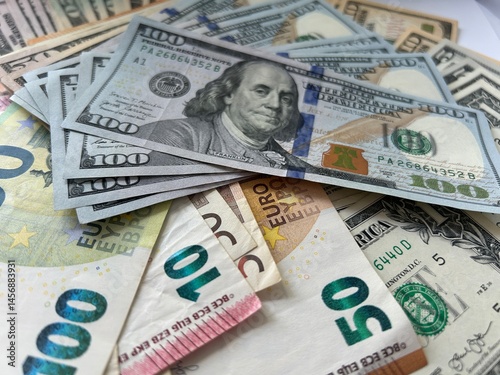 Bild auf Leinwand Close-up shot of Euro and US Dollar banknotes scattered on a flat surface, symbolizing global finance and currency exchange