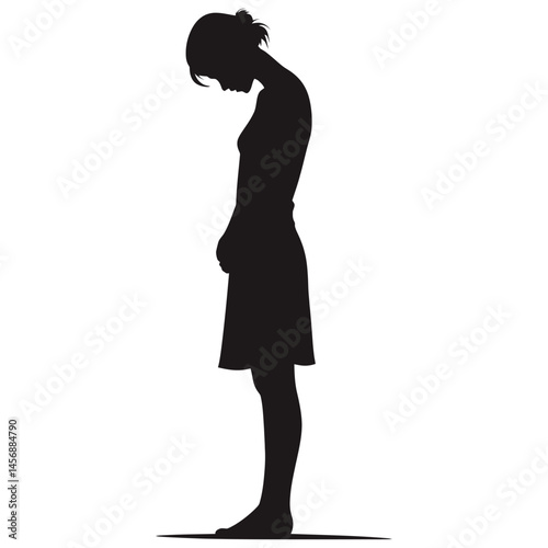 Silhouette of woman standing with head bowed in quiet reflective posture