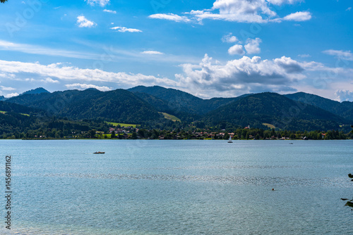 Tranquil panorama view of Tegernsee lake with Bavarian alps in background on a sunny summer day, Tegernsee, Bavaria, Germany