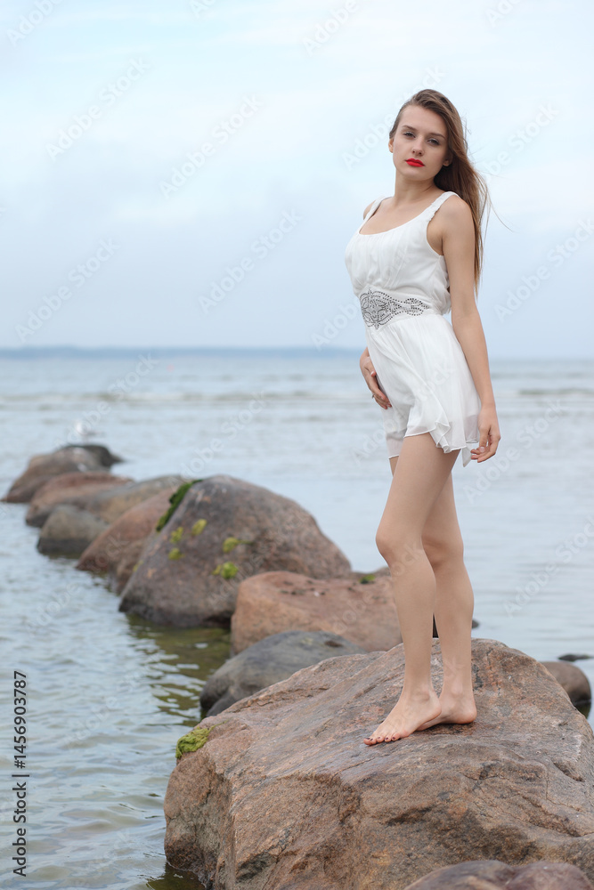 Fototapeta premium young slender woman by the sea