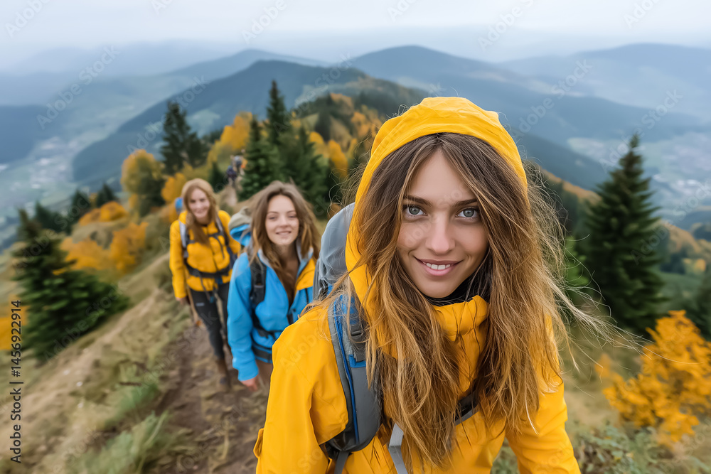 Group of friends hiking in the mountains at sunrise in summer, wearing colorful hiking clothes, smiling and enjoying the view Group of friends hiking in the mountains at sunrise in summer, wearing colorful hiking clothes, smiling and enjoying the view
