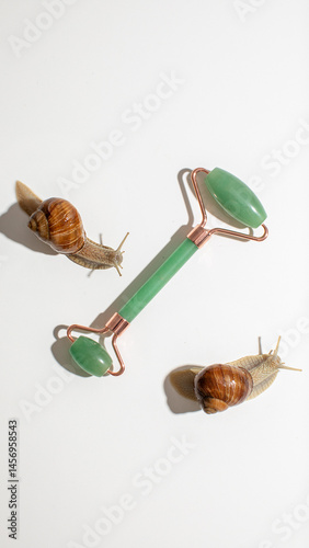 Snails encircle a jade roller, embodying skincare ritual essence, slow beauty philosophy, and World Snail Racing Day whimsy