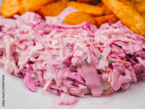 Obraz na płótnie Simple meal with pork belly, potato wedges and pink coleslaw on white plate. Fine dinner with simple products. w salonie