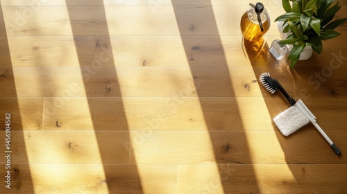 Top-down view of freshly polished floor with cleaning tools like mop and polish bottle placed neatly to the side highlighting surface shine
