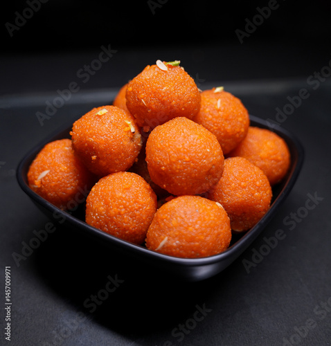 Close up of Indian traditional sweet Laddu served in a black bowl
