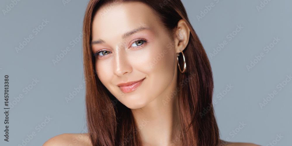 Caucasian woman with glossy brown hair, natural makeup, and radiant skin smiling softly in a clean studio portrait - ideal for beauty, skincare, wellness, or personal care brand promotions.