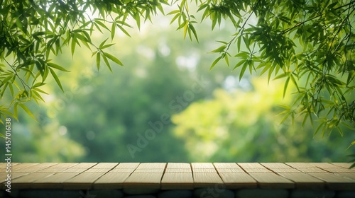 Wooden table with bamboo leaves and blurred green background.