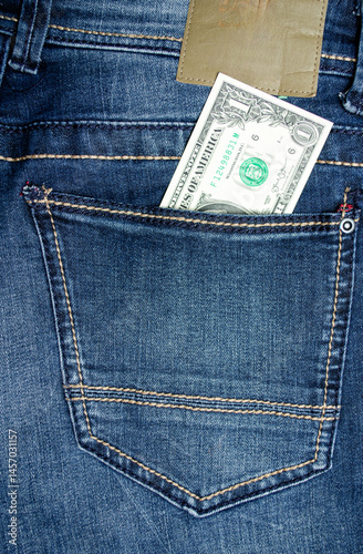 Obraz na płótnie 1 dollar lies in the pocket of blue jeans close-up w salonie