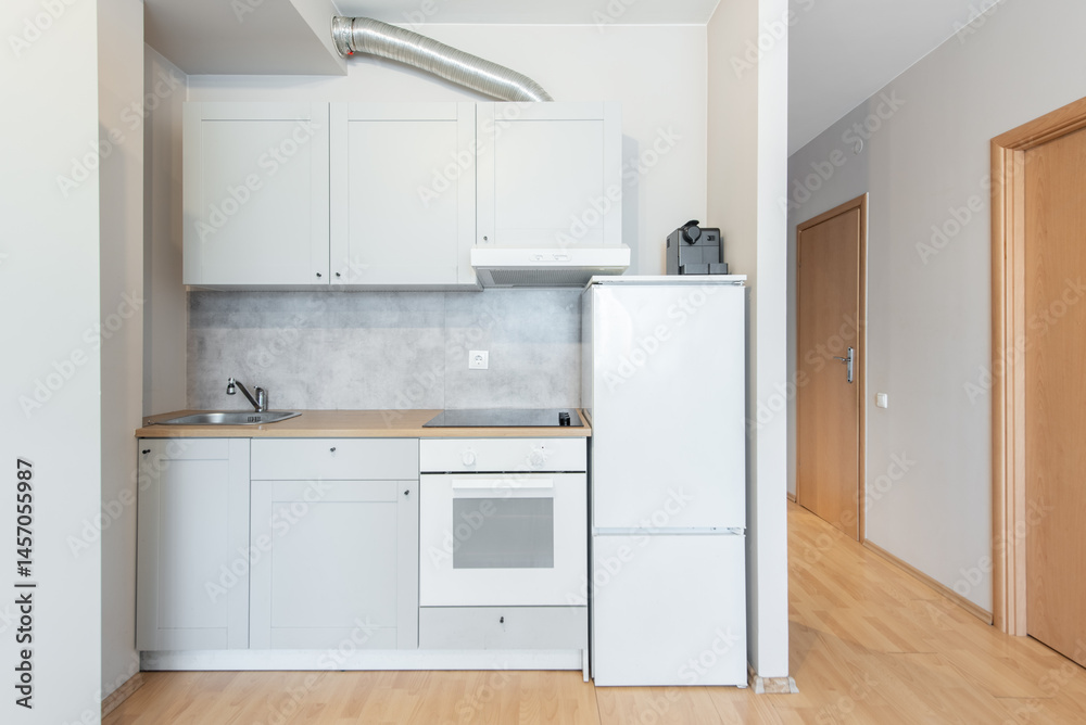 Fototapeta premium Modern Minimalist Kitchen Interior with White Cabinets and Wooden Flooring