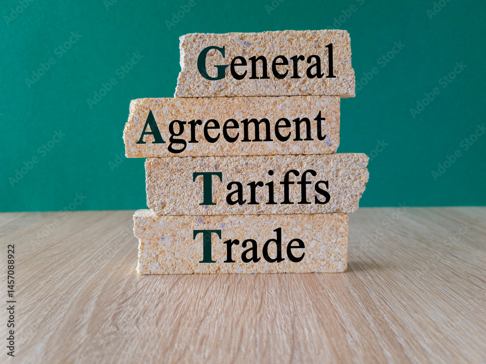 Concept words General Agreement on Tariffs and Trade acronym on brick blocks. Beautiful green background, wooden table. Business concept.