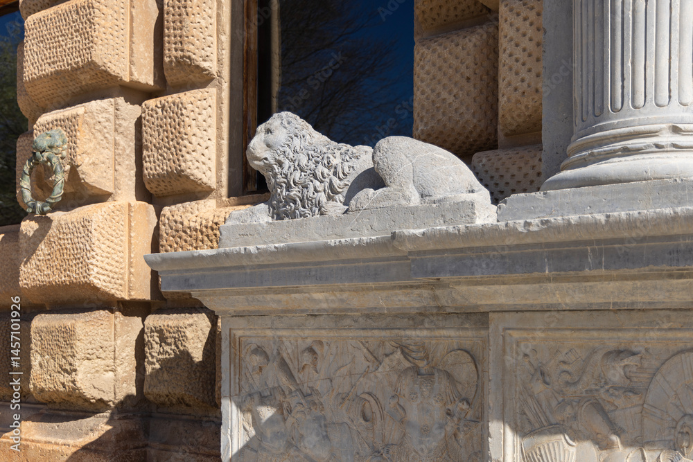 Stone lion on facade of Palace of Charles V, renaissance building inside fortress Alhambra, Granada, Spain, Andalusia