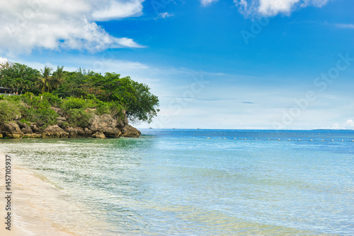 ALONA BEACH, PHILIPPINES-2024-12-21: Beautiful beach with blue waters and tourists boats, white sand and clear sky at Alona Beach, Bohol, Philippines. This was during the Christmas week. 