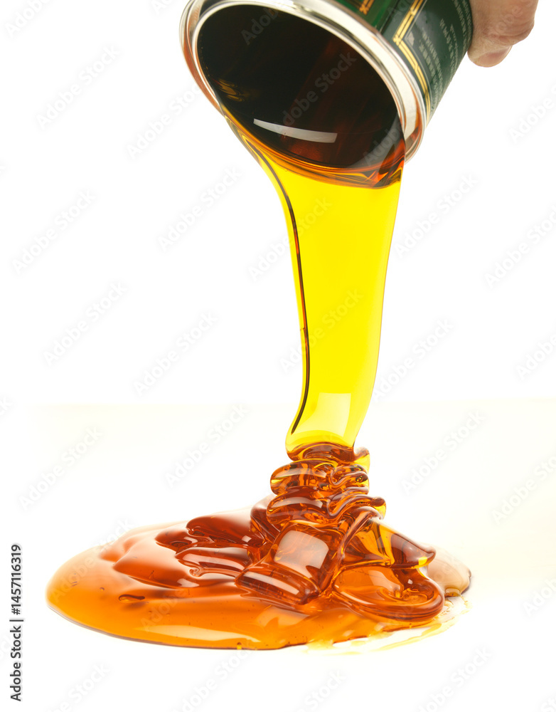 Pouring golden honey on a white background