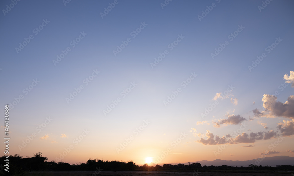Fototapeta premium Beautiful sky, sun and cloud at high. Landscape include space, light of nature, sunset, sunrise, horizon or skyline. Colorful with yellow, orange and blue color at evening time for background.