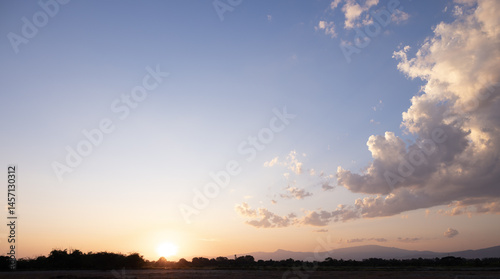 Fototapeta Naklejka Na Ścianę i Meble -  Beautiful sun sky and cloud at evening. Landscape include space, light of nature, sunset, sunrise, horizon or skyline. Colorful with yellow, orange and blue autumn for background and wallpaper.