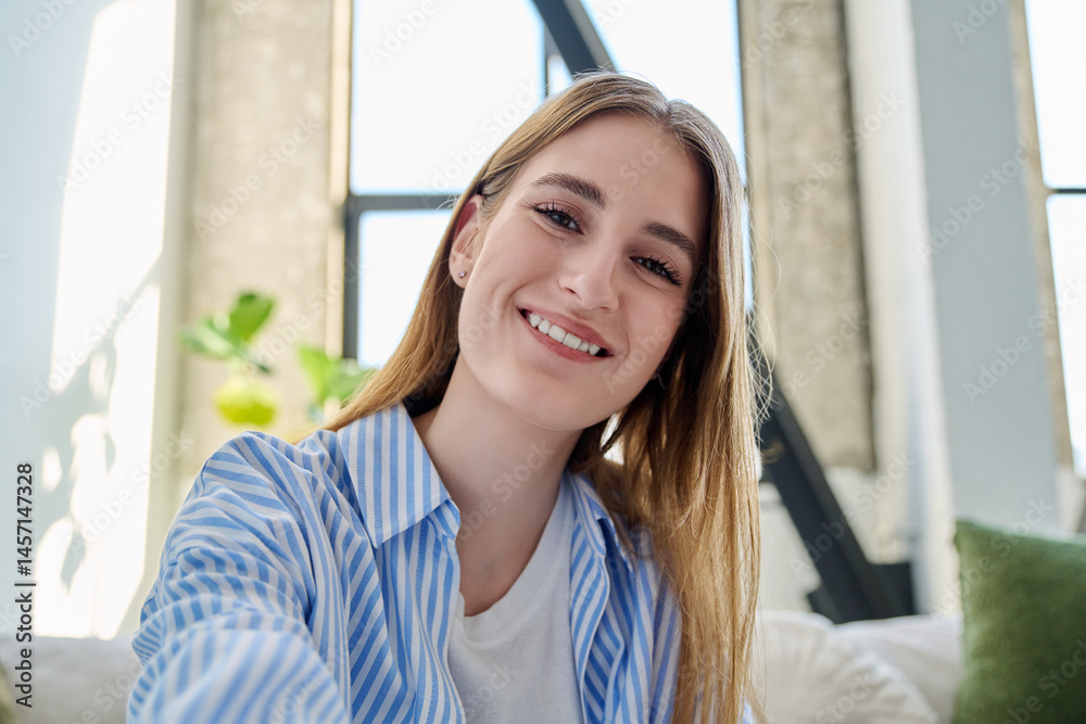 Close-up selfie portrait of teenage female looking at web camera