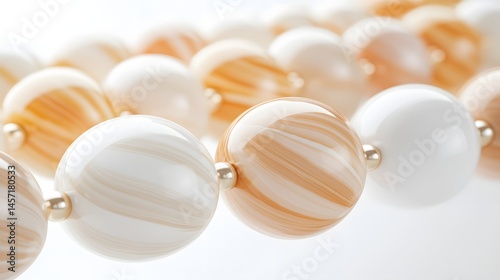 Closeup of Elegant Decorative Beads with Unique Patterns and Soft Colors on a Light Background