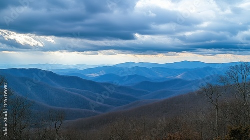 Majestic layered mountain landscape beneath a dramatic cloudy sky above