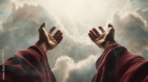 Jesus' hands open to the sky, the background is white clouds and sunlight shining through them. 