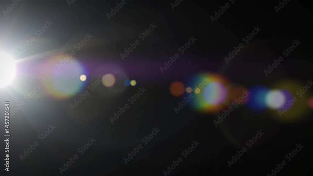 lens flare with circular refractions and gentle light bloom, appearing from darkness.mp4