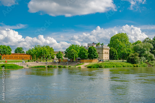 Danube Riverbank in Ingolstadt with Green Park and Cloudy Sky