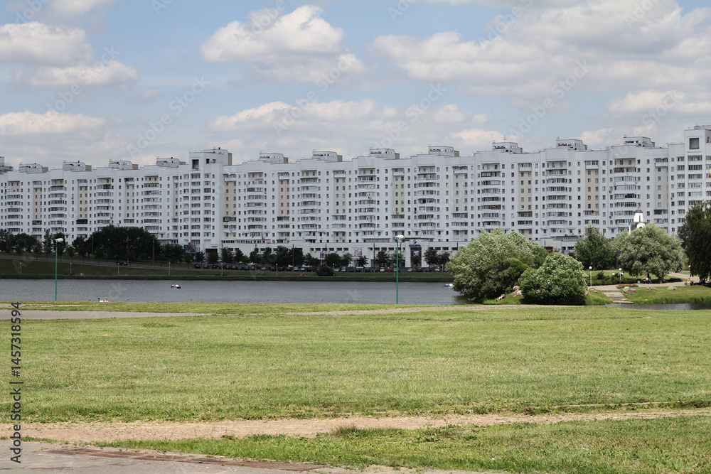 A modern white hotel building in Minsk, known as Hotel One. Bright architecture with clean lines against a blue sky. A modern white hotel building in Minsk, known as Hotel One. Bright architecture with clean lines against a blue sky.